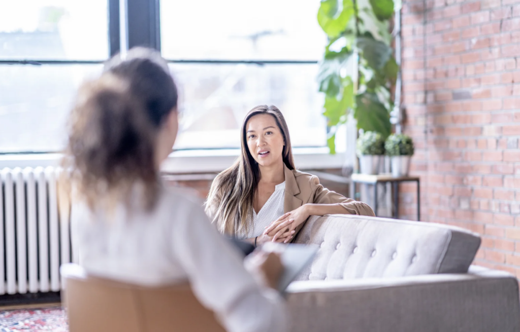 woman sitting on couch in therapy office